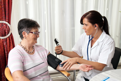 nurse measuring patient blood pressure